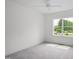 Bedroom with neutral walls and carpet, and large window providing natural light at 2617 Packhouse Rd, Zebulon, NC 27597