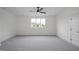Spacious bedroom with carpet, a ceiling fan, and a large window for natural light at 2617 Packhouse Rd, Zebulon, NC 27597