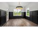 Bright dining area with wainscotting, a modern light fixture, and scenic backyard views at 2617 Packhouse Rd, Zebulon, NC 27597