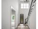 Elegant two-story foyer with modern lighting fixture, hardwood flooring, and black iron staircase at 2617 Packhouse Rd, Zebulon, NC 27597
