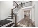 Grand foyer with hardwood floors, an elegant staircase, and views into the living area at 2617 Packhouse Rd, Zebulon, NC 27597
