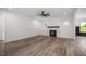 Spacious living room with wood floors, a cozy fireplace, and ample natural light at 2617 Packhouse Rd, Zebulon, NC 27597