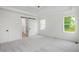 Spacious bedroom featuring neutral carpet, recessed lights, ceiling fan, and access to bathroom via sliding barn door at 2617 Packhouse Rd, Zebulon, NC 27597