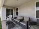 Comfortable covered back patio featuring neutral toned outdoor seating at 304 Anaconda Trl, Mebane, NC 27302