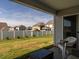 Cozy covered back patio with view of fenced yard and neighboring homes at 304 Anaconda Trl, Mebane, NC 27302