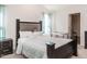 Well-lit bedroom with a comfortable bed, neutral decor, and two large windows at 304 Anaconda Trl, Mebane, NC 27302