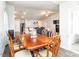 Open concept dining room featuring a wooden table, seating for six, and adjacent living room and kitchen at 304 Anaconda Trl, Mebane, NC 27302