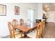 Formal dining room with wood floors, seating for six, and an adjacent view of the kitchen at 304 Anaconda Trl, Mebane, NC 27302
