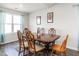 Cozy dining room featuring a wooden table with seating for six and natural light from the window at 304 Anaconda Trl, Mebane, NC 27302