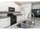 Well-equipped kitchen with granite countertops, white cabinets, and modern appliances at 304 Anaconda Trl, Mebane, NC 27302