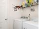 Bright laundry room with washer and dryer, shelving, and laundry room signage at 304 Anaconda Trl, Mebane, NC 27302