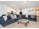 Inviting living room area with a large couch, open to the kitchen, and neutral carpet at 304 Anaconda Trl, Mebane, NC 27302