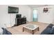 Cozy living room featuring a flat-screen TV, comfortable seating, and a neutral color scheme at 304 Anaconda Trl, Mebane, NC 27302