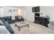 Bright living room with a large sectional sofa, TV, and neutral-colored carpet at 304 Anaconda Trl, Mebane, NC 27302