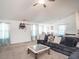 Spacious living room with neutral carpet, a large couch, and ample natural light at 304 Anaconda Trl, Mebane, NC 27302