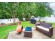 A furnished patio area features a grill and chiminea, surrounded by a privacy fence and lush landscaping at 313 Weeping Willow Dr, Durham, NC 27704