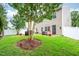 A large backyard features a privacy fence, patio area, and mature trees at 313 Weeping Willow Dr, Durham, NC 27704