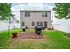 The backyard features a paved patio with room for grilling and outdoor seating and a privacy fence at 313 Weeping Willow Dr, Durham, NC 27704
