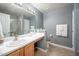 Bathroom featuring a white vanity, large mirror, and a glass-enclosed shower at 313 Weeping Willow Dr, Durham, NC 27704