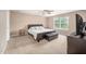 Spacious bedroom with a leather bed, side tables, and a large window for natural light at 313 Weeping Willow Dr, Durham, NC 27704