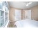 Clean bedroom with white walls, carpeted floors, large windows, and a double door closet at 313 Weeping Willow Dr, Durham, NC 27704