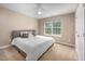 Bright, minimalist bedroom with a neutral color scheme, comfortable queen-size bed, and a ceiling fan at 313 Weeping Willow Dr, Durham, NC 27704