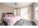A comfortable bedroom with a ceiling fan, closet, and a large window for natural light at 313 Weeping Willow Dr, Durham, NC 27704