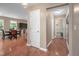 Hallway view with light wood floors leading to a dining area and laundry room at 313 Weeping Willow Dr, Durham, NC 27704