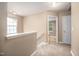 Upstairs hallway featuring carpeted floors and multiple doorways leading to bedrooms and bathrooms at 313 Weeping Willow Dr, Durham, NC 27704