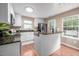 Well-lit kitchen showcasing white cabinetry, granite countertops, and modern stainless steel appliances at 313 Weeping Willow Dr, Durham, NC 27704