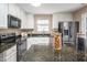 Open kitchen with stainless steel appliances, granite countertops, and ample storage space at 313 Weeping Willow Dr, Durham, NC 27704