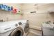 Laundry room with a sink, washer, dryer, and wire shelving at 313 Weeping Willow Dr, Durham, NC 27704