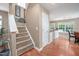 Carpeted staircase leading to the upper level, next to the kitchen and dining area at 313 Weeping Willow Dr, Durham, NC 27704