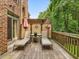 Spacious wooden deck with lounge chairs, umbrellas, and wooden railing offers a peaceful outdoor retreat at 3347 Ridgecrest Ct, Raleigh, NC 27607