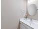 Elegant bathroom with a round mirror, white vanity, and stylish fixtures at 3347 Ridgecrest Ct, Raleigh, NC 27607
