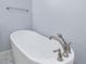 Freestanding white bathtub with modern fixtures and bright lighting at 3347 Ridgecrest Ct, Raleigh, NC 27607