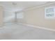 Spacious bedroom with neutral paint, white trim, white carpet, and a window at 3347 Ridgecrest Ct, Raleigh, NC 27607