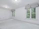 Bright bedroom featuring neutral paint, white trim, white carpet, and many windows at 3347 Ridgecrest Ct, Raleigh, NC 27607