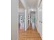 Hallway with light hardwood floors and views into other rooms at 3347 Ridgecrest Ct, Raleigh, NC 27607