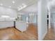 Open concept kitchen with white cabinetry and a large island overlooking the living area at 3347 Ridgecrest Ct, Raleigh, NC 27607