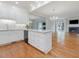 Open concept kitchen with white cabinetry and a large island overlooking the living area at 3347 Ridgecrest Ct, Raleigh, NC 27607