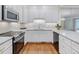 Charming kitchen with granite countertops, stainless steel appliances, and white cabinets at 3347 Ridgecrest Ct, Raleigh, NC 27607