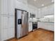 Bright kitchen with stainless steel appliances, white cabinets, and hardwood floor at 3347 Ridgecrest Ct, Raleigh, NC 27607