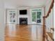 Living room featuring a black fireplace, hardwood floors and glass doors that lead to the outdoor deck at 3347 Ridgecrest Ct, Raleigh, NC 27607