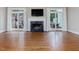 Living room has fireplace with mantle, hardwood floors, and glass doors that lead to the deck at 3347 Ridgecrest Ct, Raleigh, NC 27607