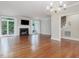 Open living room features a fireplace, hardwood floors, and sliding glass doors to an outdoor deck at 3347 Ridgecrest Ct, Raleigh, NC 27607