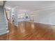 Spacious living room featuring hardwood floors, stairs, and an open layout connecting to the kitchen at 3347 Ridgecrest Ct, Raleigh, NC 27607