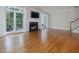 Bright living room with hardwood floors, fireplace, and glass doors that lead to the outdoor living space at 3347 Ridgecrest Ct, Raleigh, NC 27607