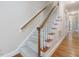 Carpeted staircase features wooden handrails and leads to the upper level of the home at 3347 Ridgecrest Ct, Raleigh, NC 27607