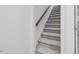 Carpeted staircase features wood handrail, providing a seamless transition between levels in the home at 3347 Ridgecrest Ct, Raleigh, NC 27607